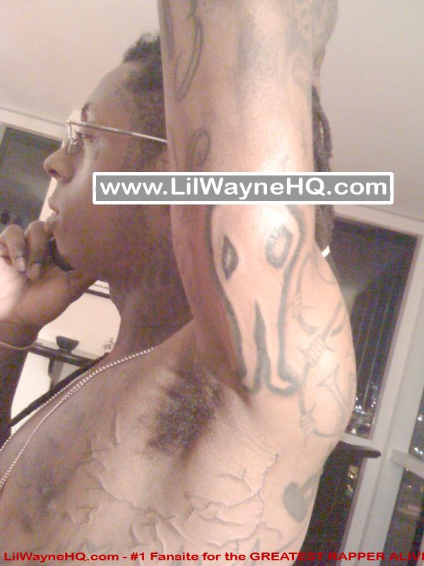 Side of chest and arm which has an alien tattoo to represent he is a martian