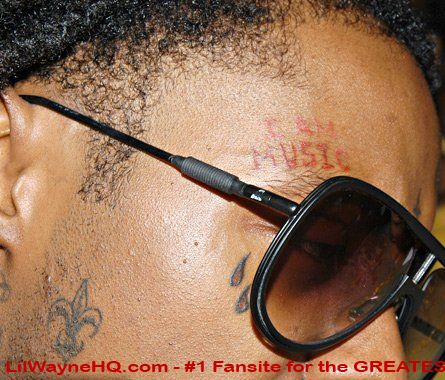 Here you see his'I Am Music' tears New Orleans symbol tattoos