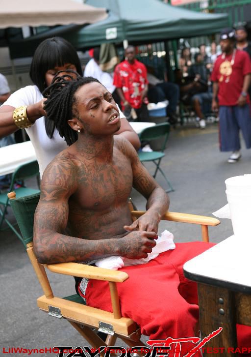 Lil Wayne Tattoos He has 'Baby' and 'Slim' on both shoulders and a bird for 
